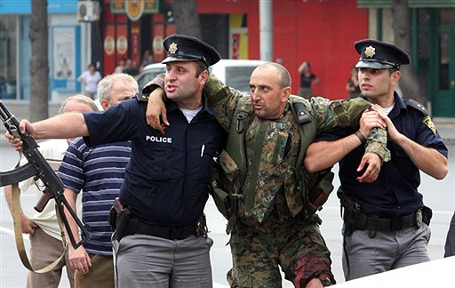 Wounded Georgian soldier, supported by Georgian police