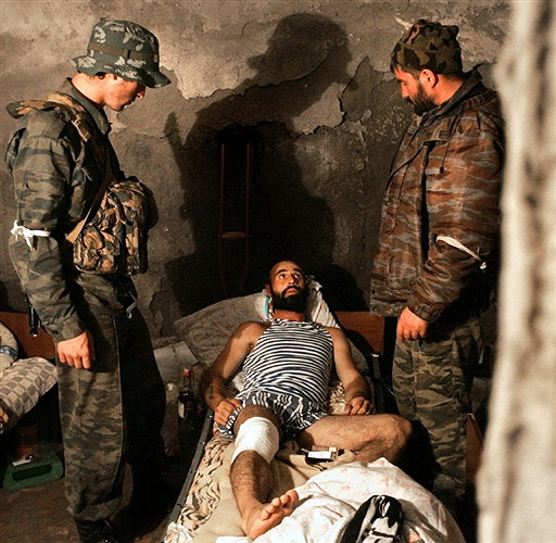 Wounded Ossetian soldier in the basement of the destroyed Zhinvali hospital